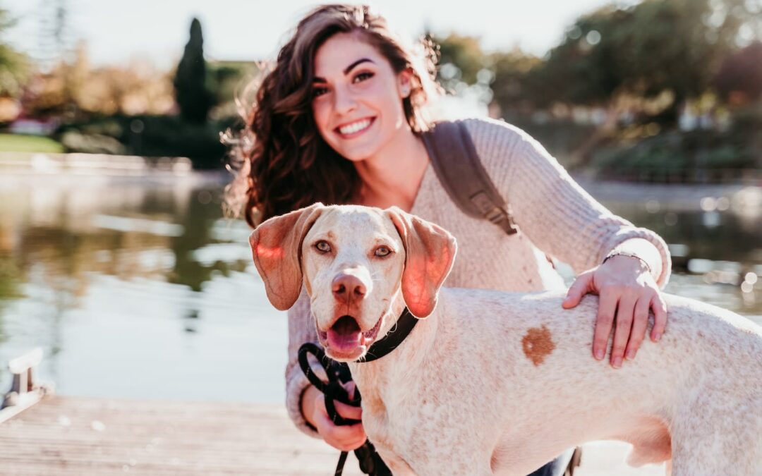 young woman and her dog outdoors in a park